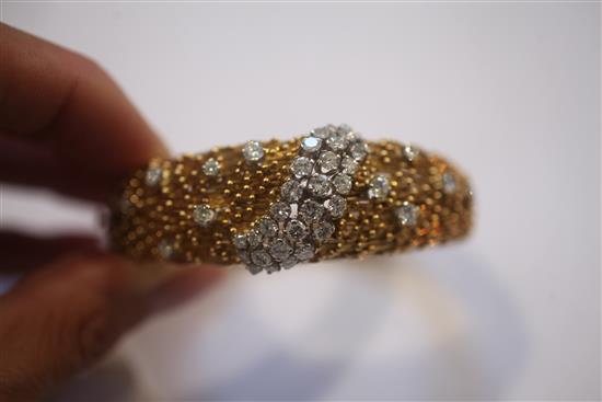 An 18ct yellow gold and diamond hinged bangle, of rod and sphere design, gross weight 59.3 grams.